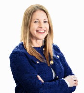 Woman with long blonde hair and red lipstick smiling in a blue suit